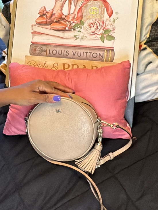 Michael Kors Handbags - Michael Kors Beige Round Crossbody Bag with Tassel Charm